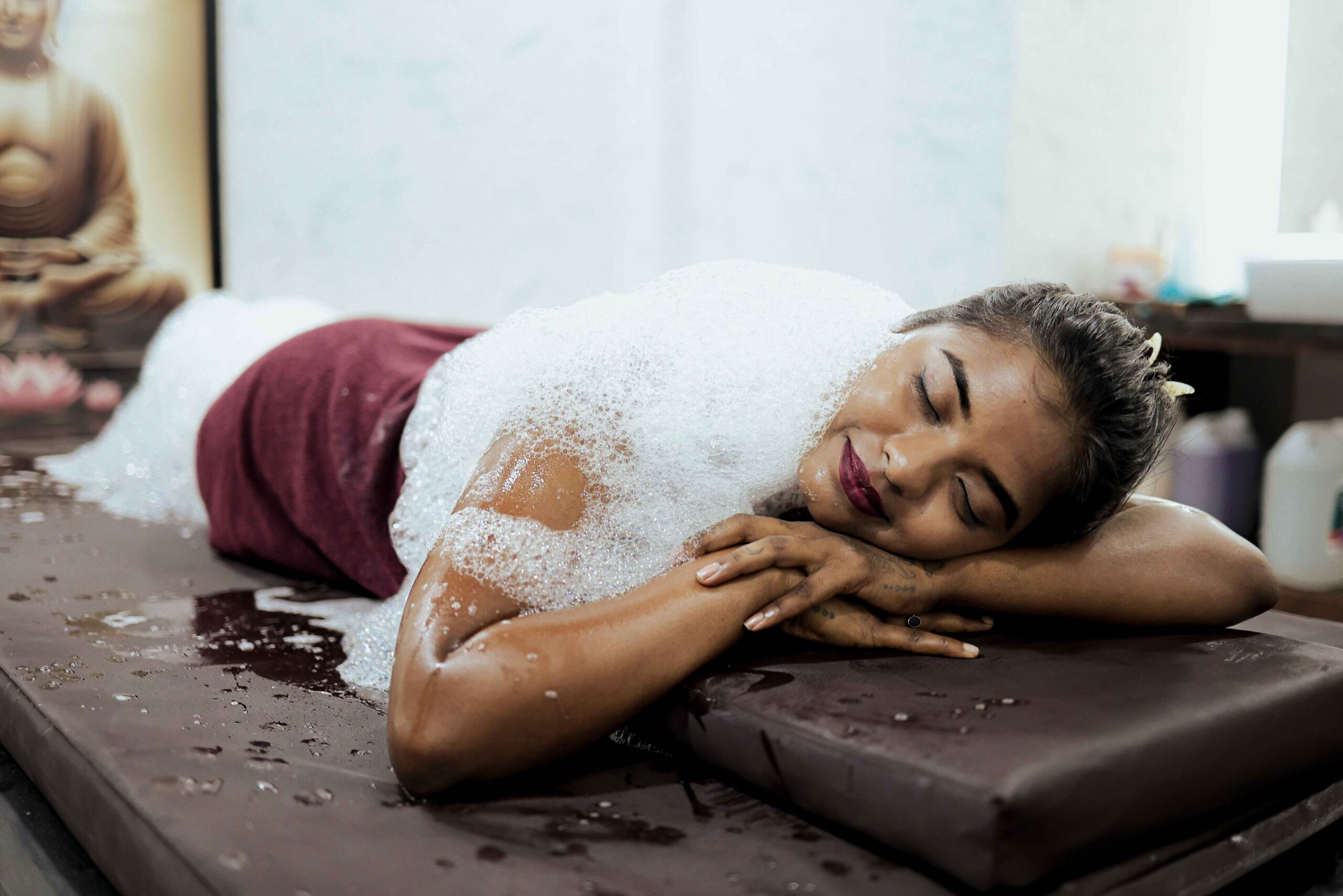 Person receiving a relaxing foam massage at a spa.